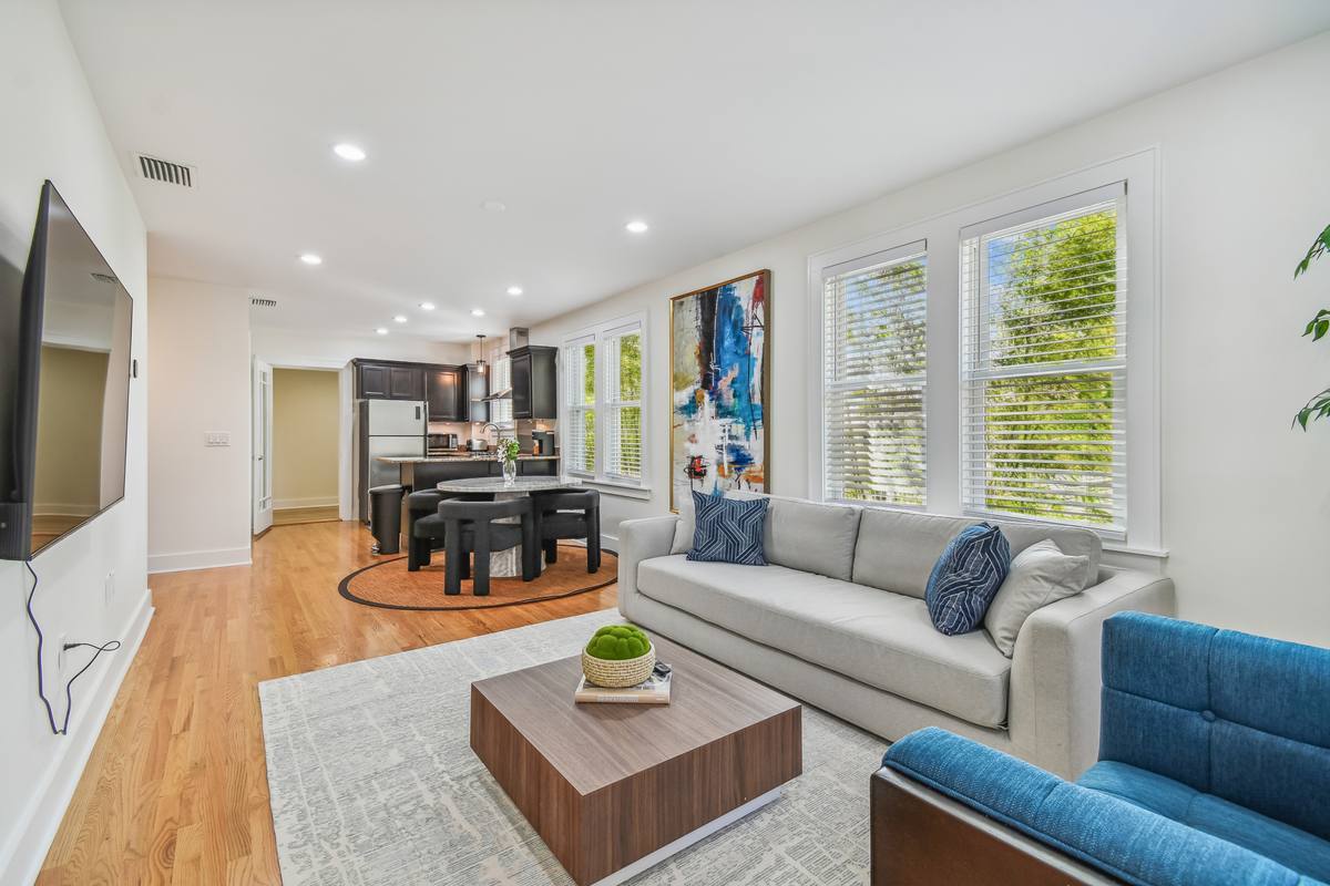 Open living room with sectional and statement art at St. Pete downtown rental
