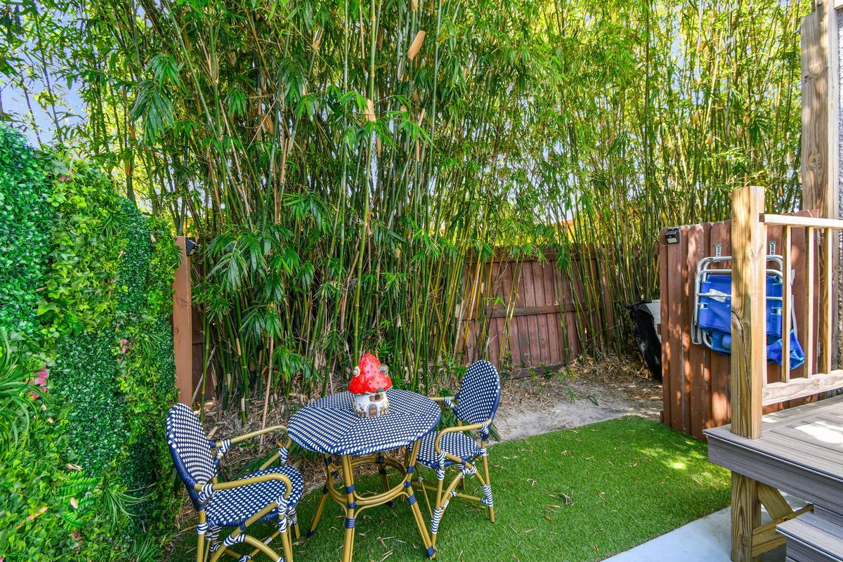 Bamboo-enclosed garden patio with bistro dining at St. Pete bungalow