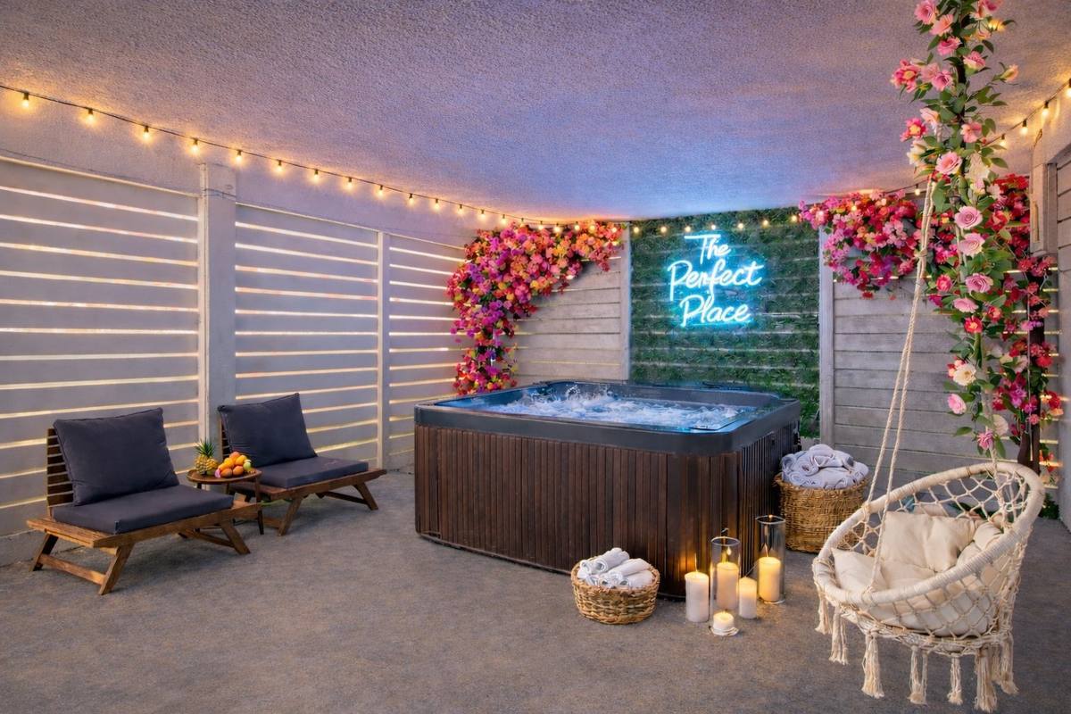 Hot tub deck with string lights and lounge seating at IRB beach house