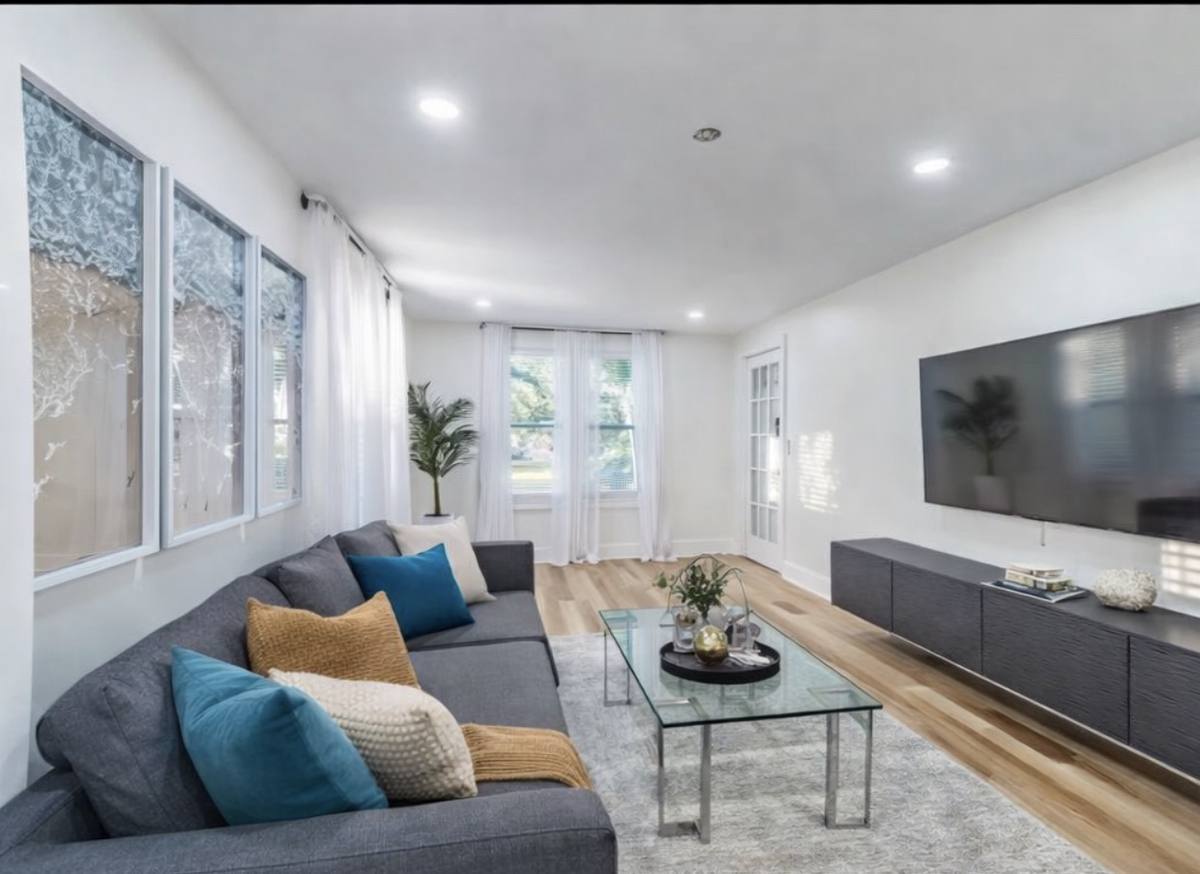 Living room with sectional and smart TV at downtown St. Pete bungalow