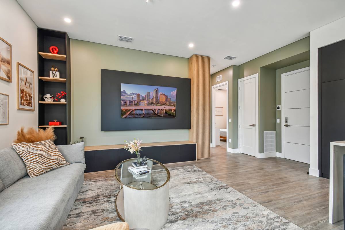 Open living room with city skyline art and king bedroom view at St. Pete rental