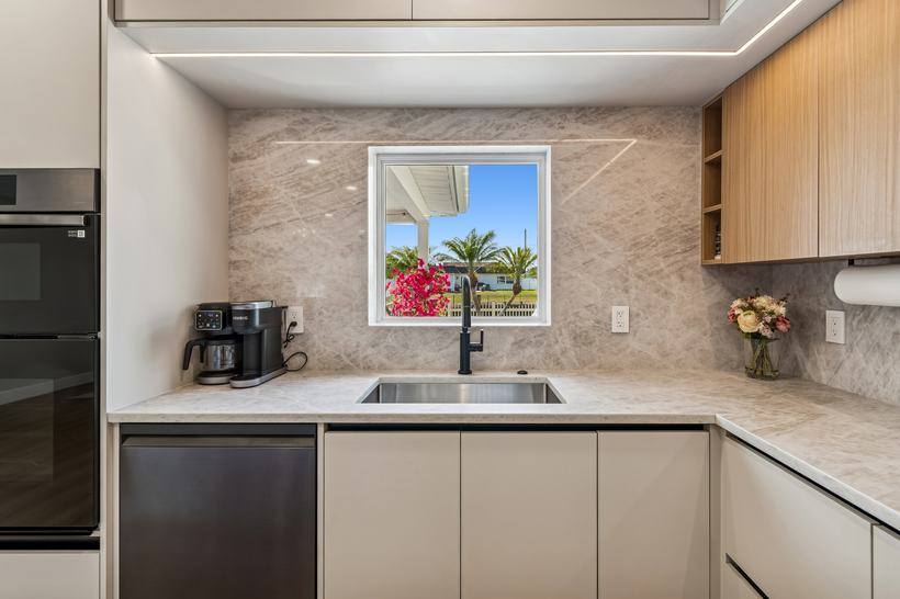 Renovated kitchen sink and quartz counters with tropical view at Tampa rental