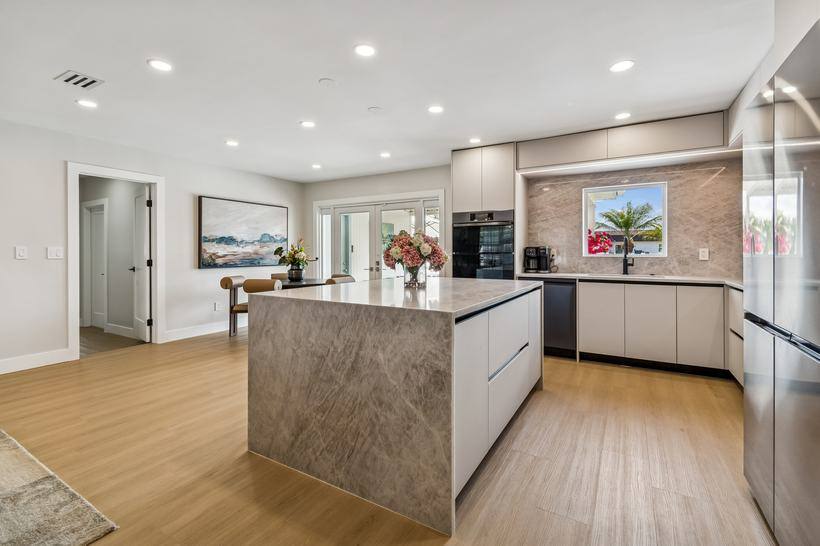 Open chef kitchen with marble island and bar seating at Tampa 6-bedroom rental